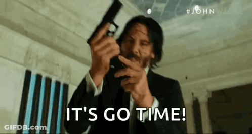 Man In Suit Holding Gun Says Its Go Time GIF