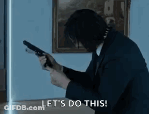 Man In Suit Holding Gun Says Lets Do This GIF