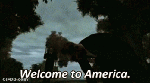 Man In Suit Holding Gun Welcome To America GIF