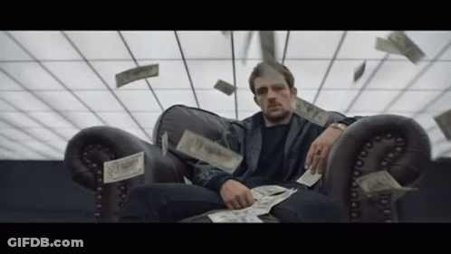 Man In Suit Holding Gun With Dollar Bill GIF