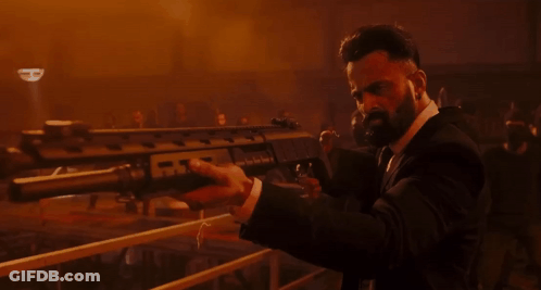 Man In Suit Holding Gun With Letter R GIF