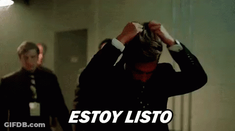 Man In Suit Holding Hair While Another Stands Behind GIF