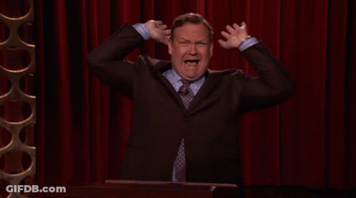 Man In Suit Holding Hands To Head GIF