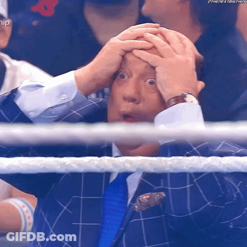 Man In Suit Holding Head Watching Wrestling GIF