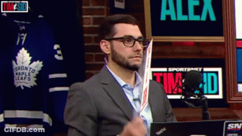Man In Suit Holding Hockey Stick Sportsnet Sign GIF