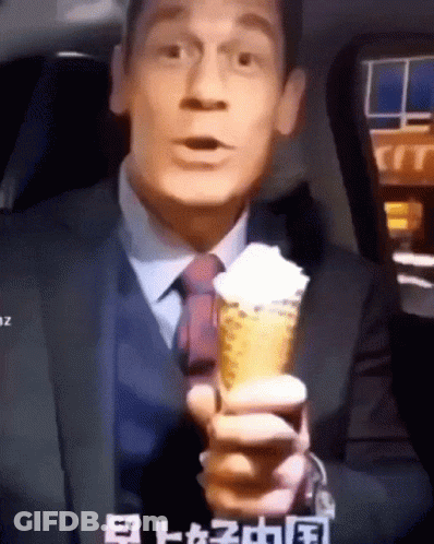 Man In Suit Holding Ice Cream Cone With Whipped Cream GIF