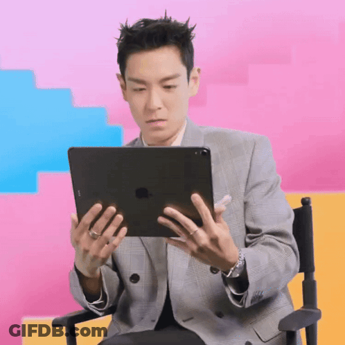 Man In Suit Holding IPad In Director's Chair GIF
