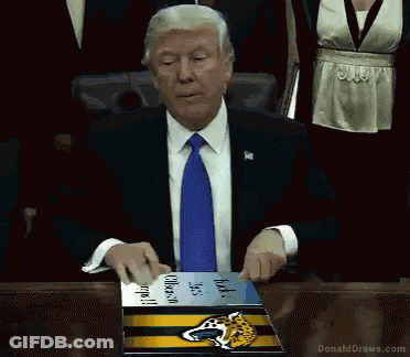 Man In Suit Holding Jaguars Book GIF