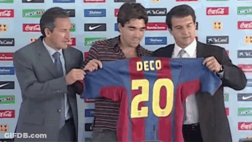 Man In Suit Holding Jersey Number 20 GIF