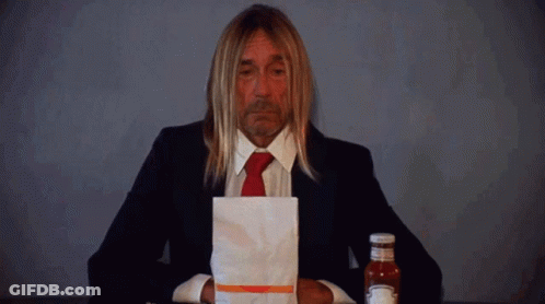 Man In Suit Holding Ketchup Bag Next To Bottle GIF