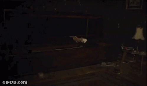 Man In Suit Holding Knife In Dark Room GIF