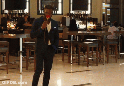 Man In Suit Holding Lollipop GIF