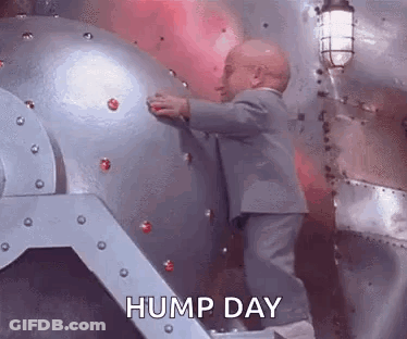 Man In Suit Holding Metal Object GIF