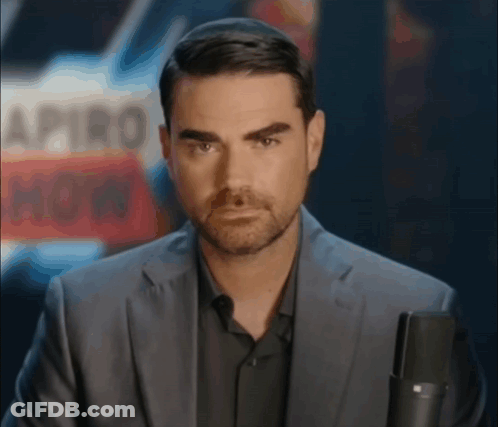 Man In Suit Holding Microphone GIF