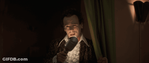 Man In Suit Holding Microphone GIF