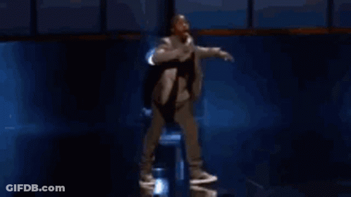 Man In Suit Holding Microphone GIF