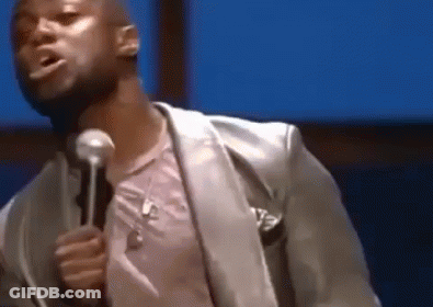 Man In Suit Holding Microphone And Talking GIF