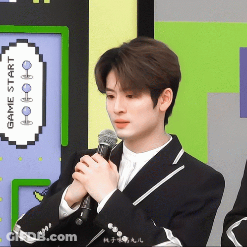 Man In Suit Holding Microphone At Game Start Sign GIF