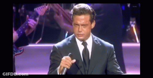 Man In Suit Holding Microphone GIF