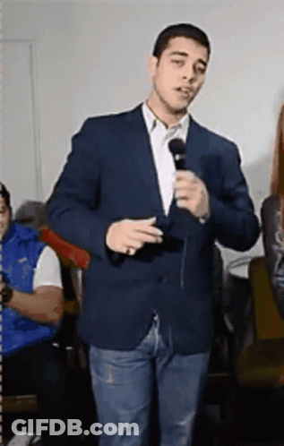 Man In Suit Holding Microphone GIF