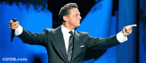 Man In Suit Holding Microphone Pointing GIF