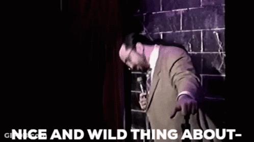 Man In Suit Holding Microphone GIF