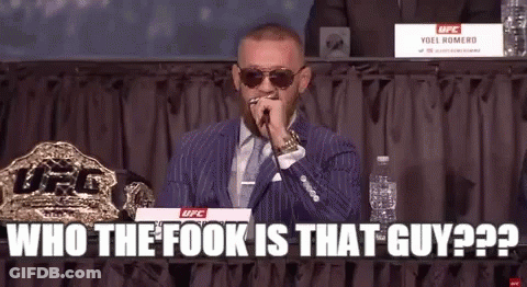 Man In Suit Holding Microphone GIF