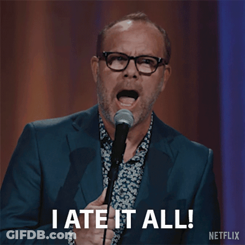Man In Suit Holding Microphone Saying I Ate It All GIF