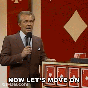 Man In Suit Holding Microphone Saying Now Let's Move On GIF