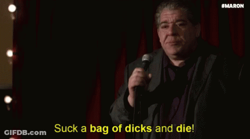 Man In Suit Holding Microphone Saying Suck A Bag Of Dicks And Die GIF