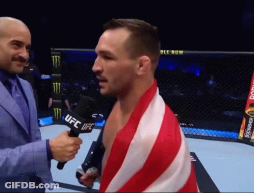 Man In Suit Holding Microphone Saying UFC GIF