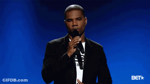 Man In Suit Holding Microphone Says Bet GIF