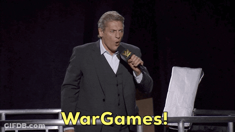 Man In Suit Holding Microphone Says Wargames GIF