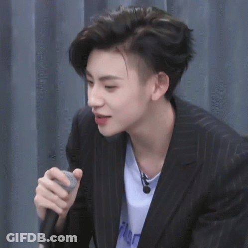 Man In Suit Holding Microphone GIF