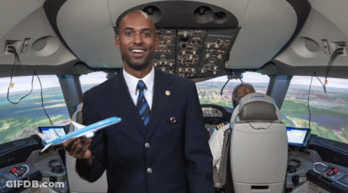 Man In Suit Holding Model Airplane GIF