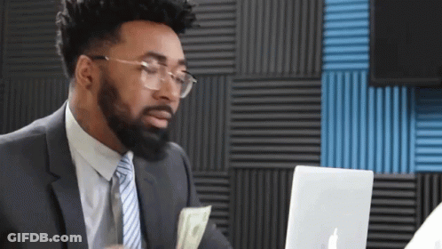 Man In Suit Holding Money In Front Of Laptop GIF
