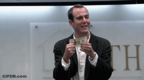 Man In Suit Holding Money In Front Of Sign Saying Th GIF
