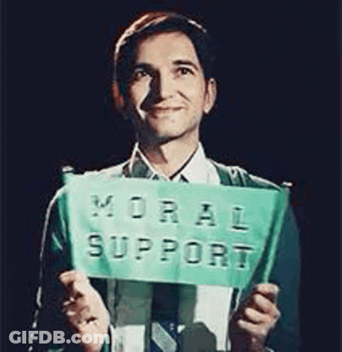 Man In Suit Holding Moral Support Sign GIF