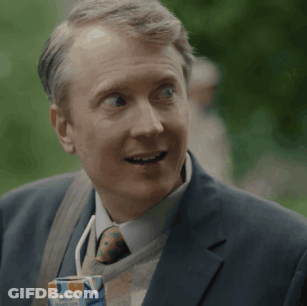 Man In Suit Holding Orange Juice GIF