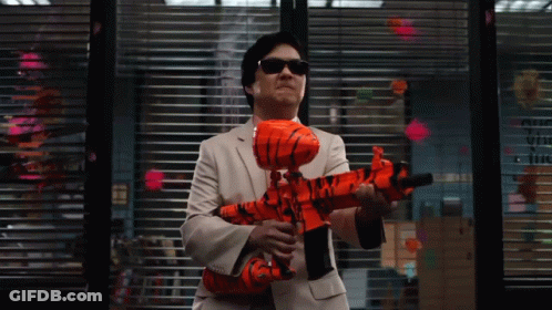 Man In Suit Holding Orange Toy Gun By Window With Sticky Notes GIF