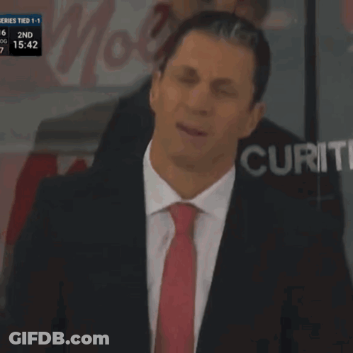 Man In Suit Holding Paper At Securit Screen GIF