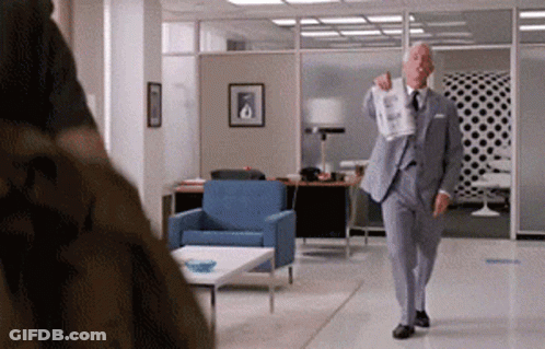 Man In Suit Holding Paper GIF