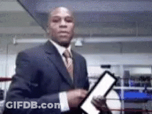Man In Suit Holding Paper Boxing Ring GIF