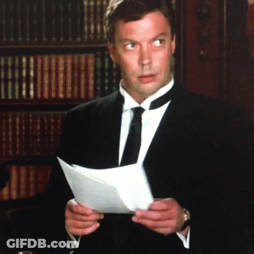 Man In Suit Holding Paper GIF