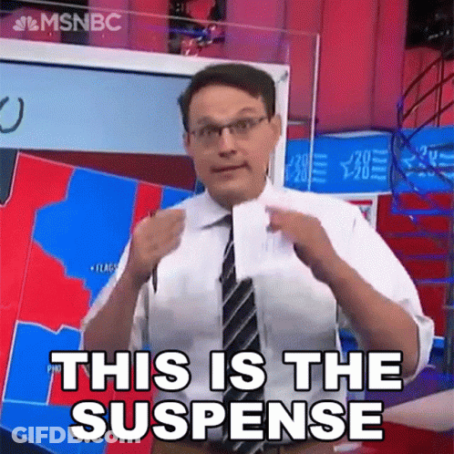 Man In Suit Holding Paper Saying This Is The Suspense GIF