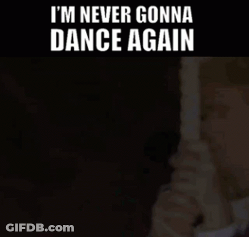Man In Suit Holding Paper With I'm Never Gonna Dance Again GIF