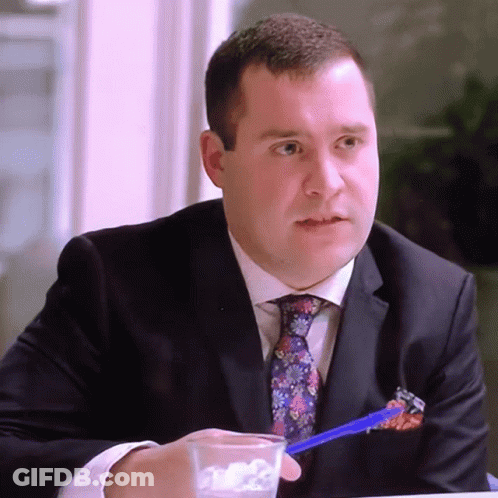 Man In Suit Holding Pen In Pocket GIF