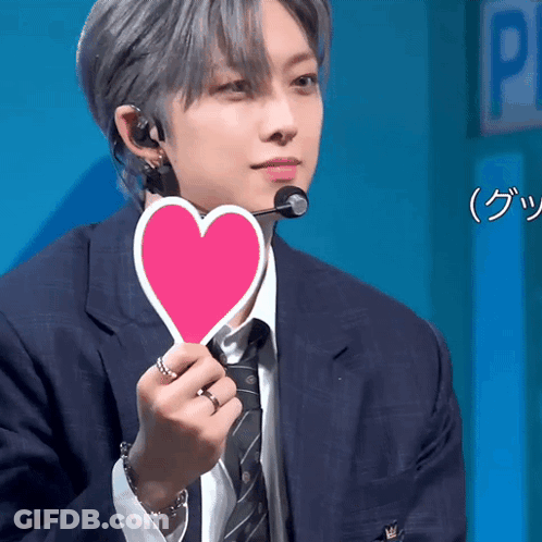Man In Suit Holding Pink Heart GIF