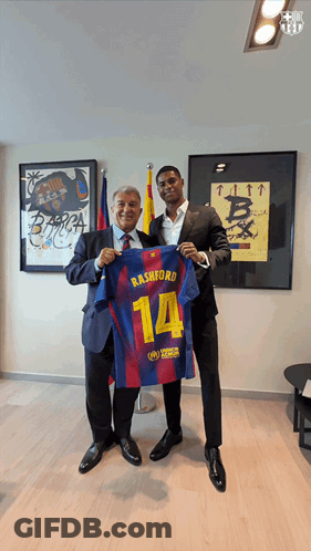 Man In Suit Holding Rashford Jersey GIF