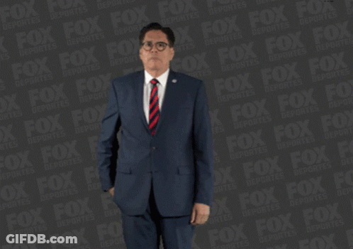 Man In Suit Holding Red Item By Fox Advertisement GIF